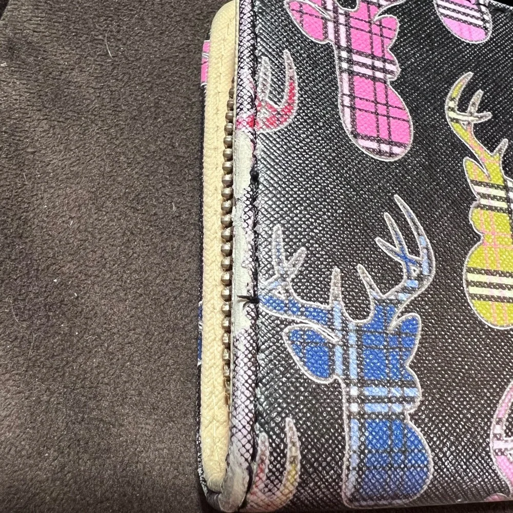 Simply southern wallet. Lots of slots for card and zips shut. Has some wear